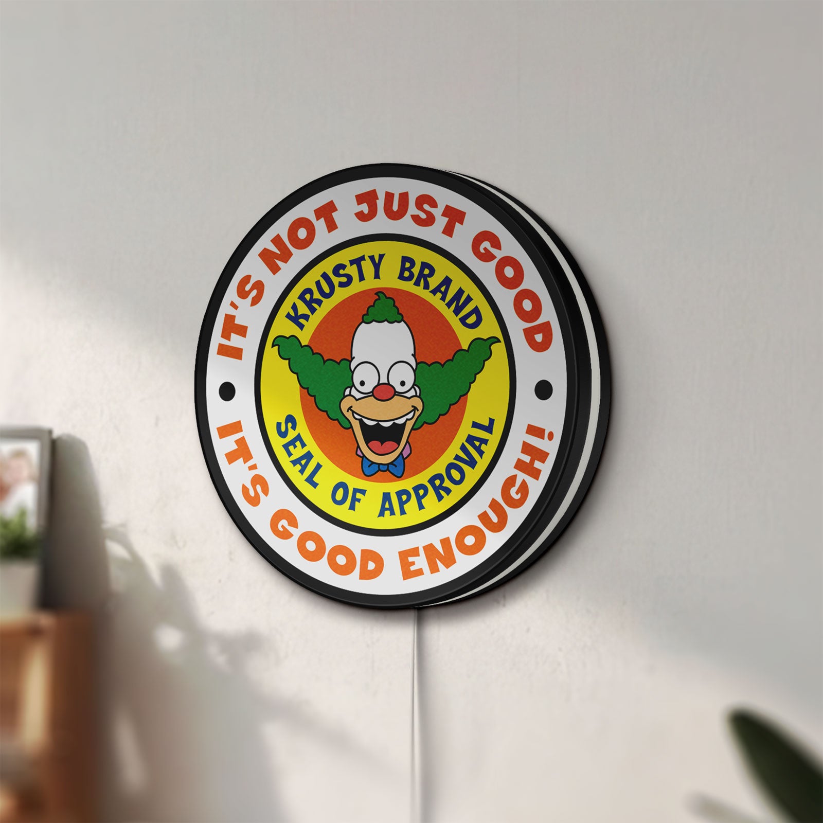 Unlit The Simpsons LED lightbox mounted on a wall in daylight