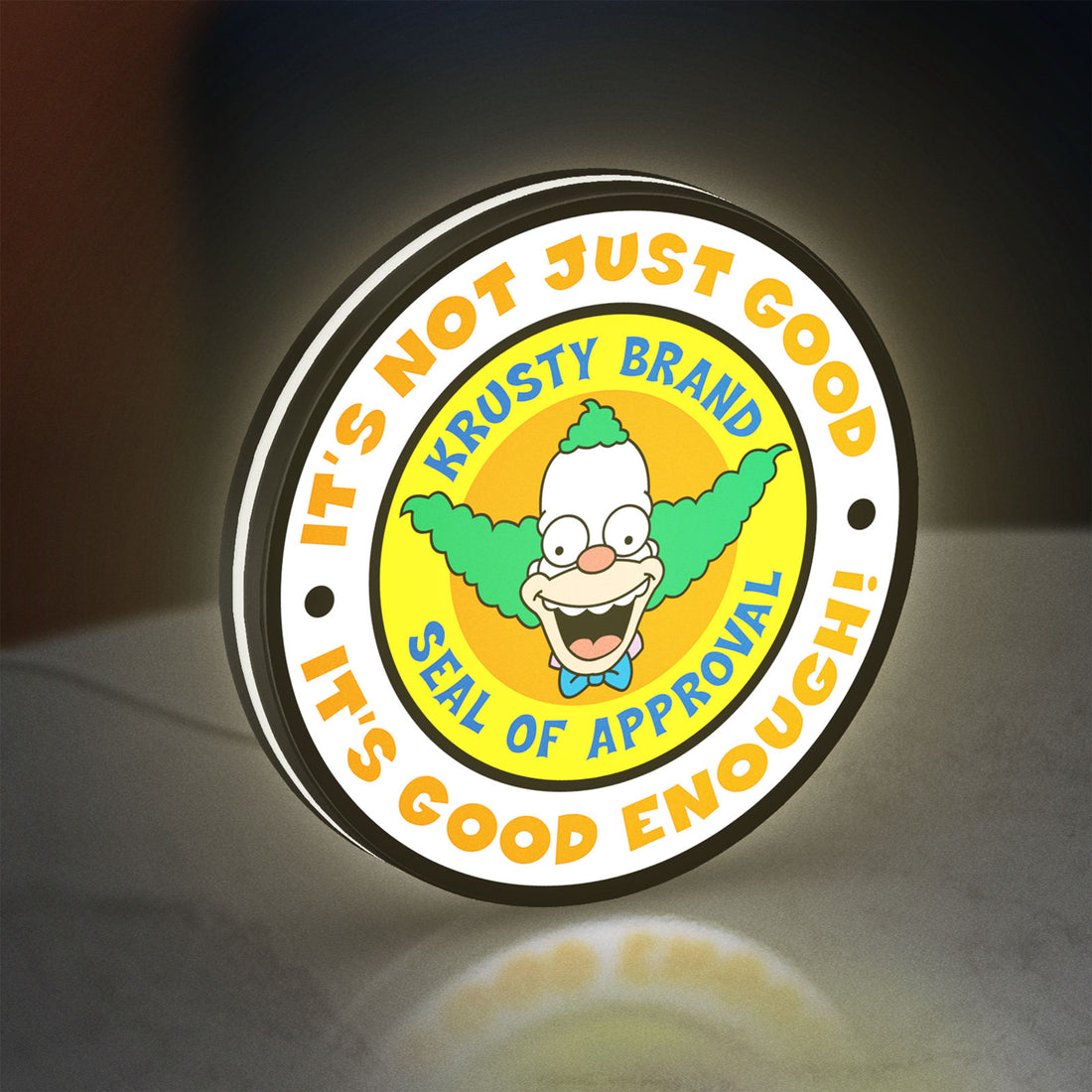 The Simpsons LED lightbox hanging on a wall with white glow