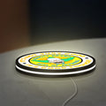 The Simpsons LED lightbox lying flat on a desk with white glow