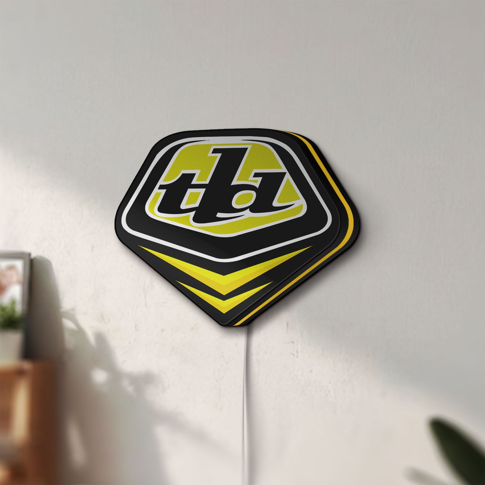 Unlit Troy Lee Designs LED lightbox mounted on a wall in daylight