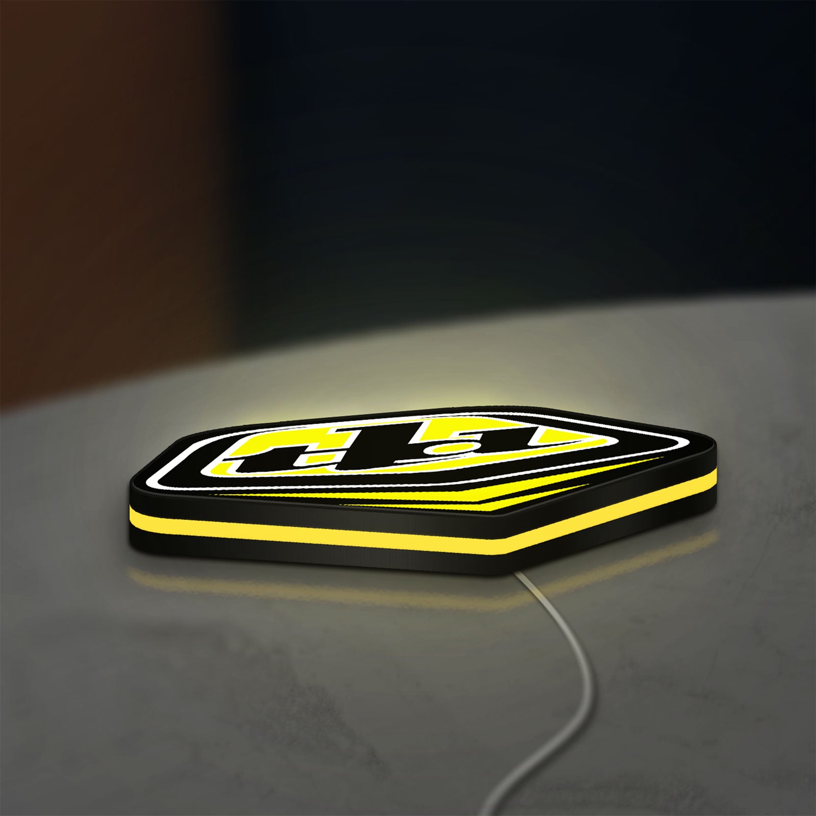 Troy Lee Designs LED lightbox lying flat on a desk with yellow glow