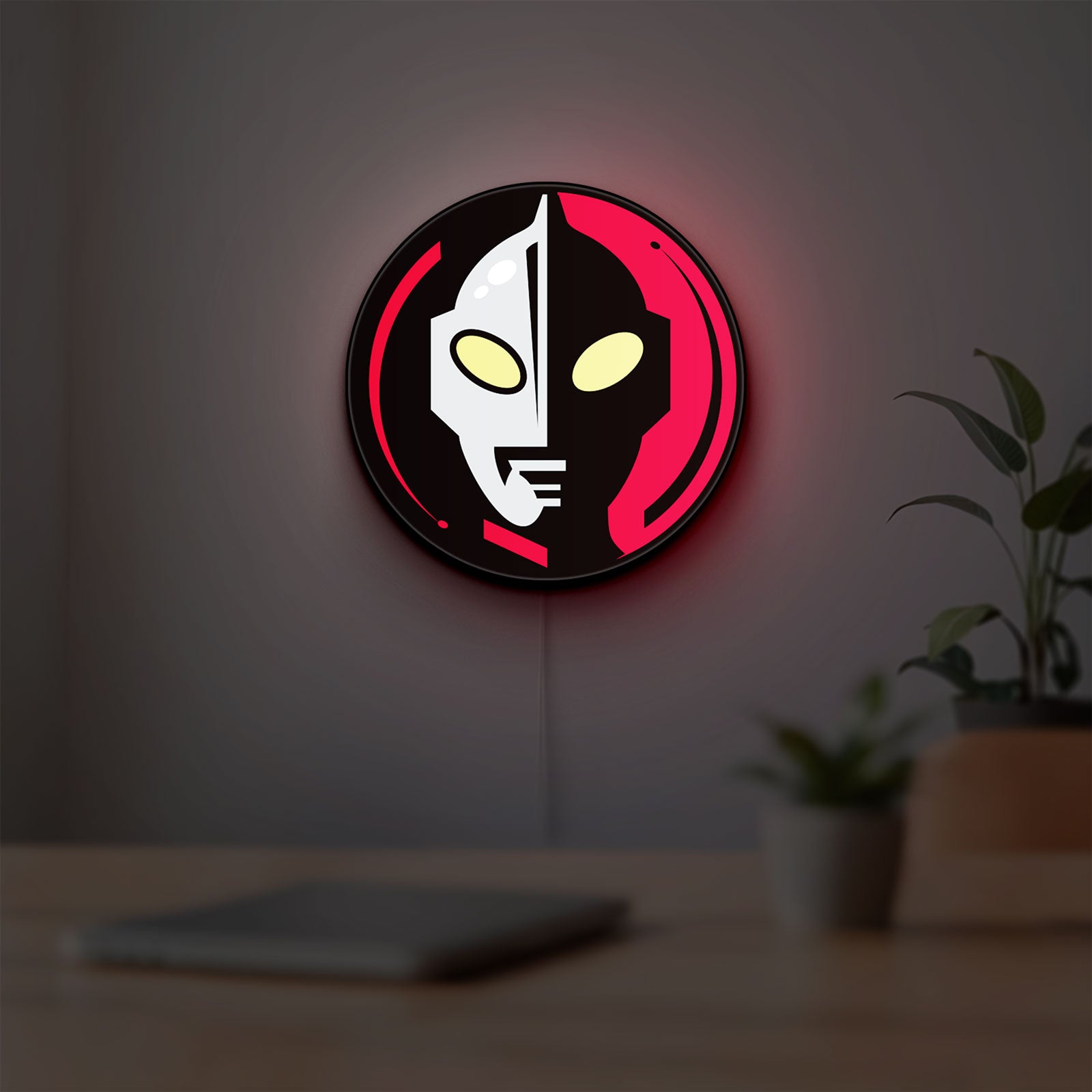 Ultraman LED lightbox hanging on a room wall with soft red light
