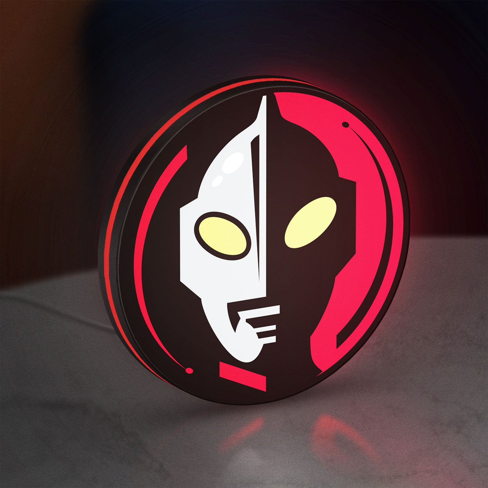 Ultraman LED lightbox standing on a desk from an angled side view with red glow
