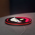 Ultraman LED lightbox lying flat on a desk with red glow