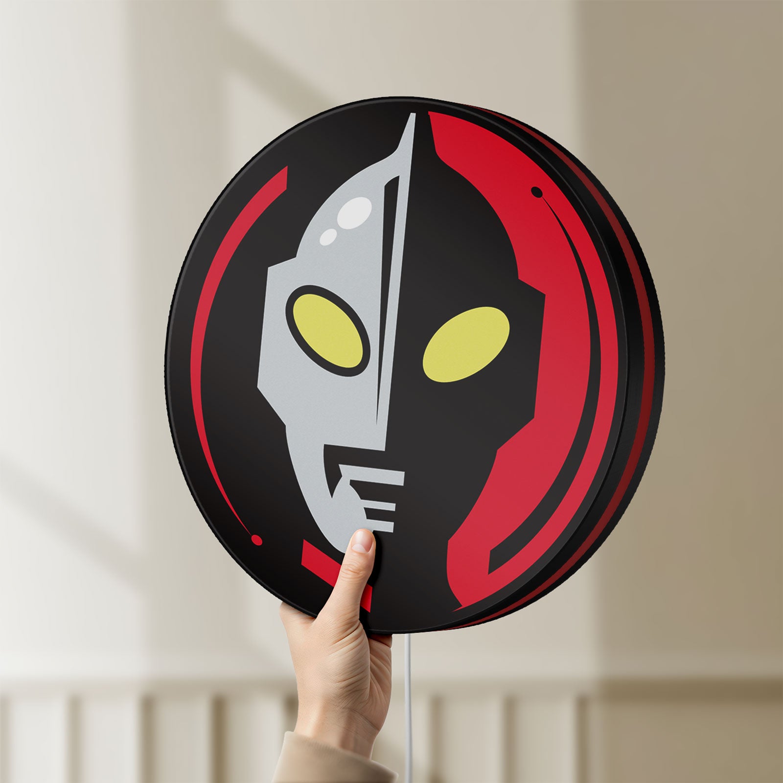 Unlit Ultraman LED lightbox held by hand to show size and details