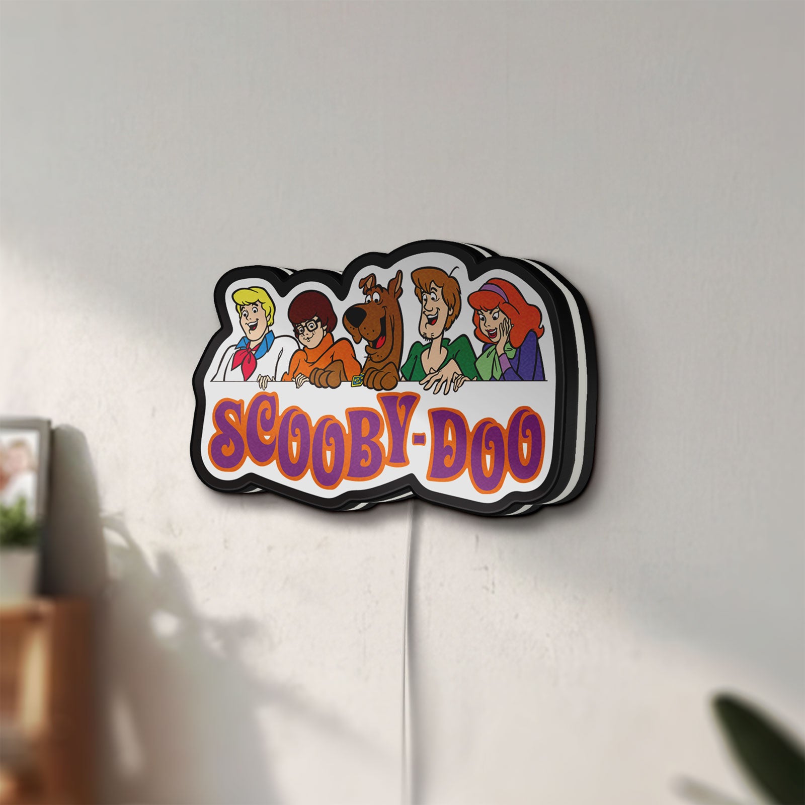 Unlit Scooby Doo LED lightbox mounted on a wall in daylight