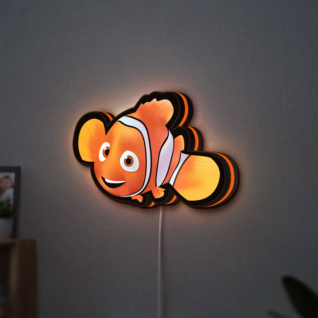 Sharan Rudrox Nemo Mesh LED lightbox hanging on a wall with orange glow