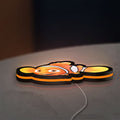 Sharan Rudrox Nemo Mesh LED lightbox lying flat on a desk with orange glow