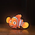 Front view of Sharan Rudrox Nemo Mesh LED lightbox sign glowing on a wooden desk
