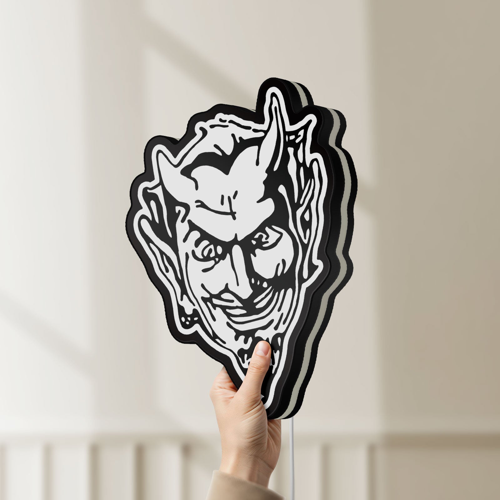 Unlit Devil Head LED lightbox held by hand to show size and details