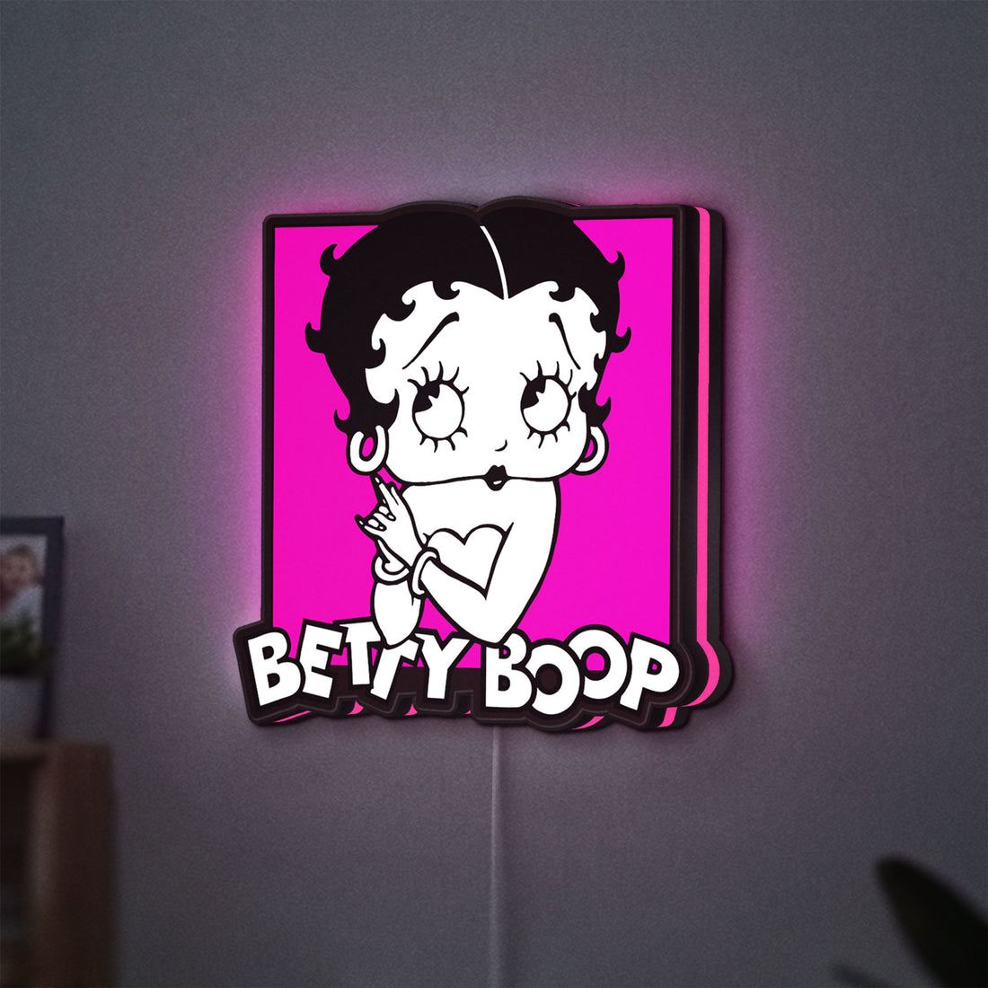 Betty Boop LED lightbox hanging on a wall with pink glow