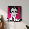 Unlit Betty Boop LED lightbox mounted on a wall in daylight