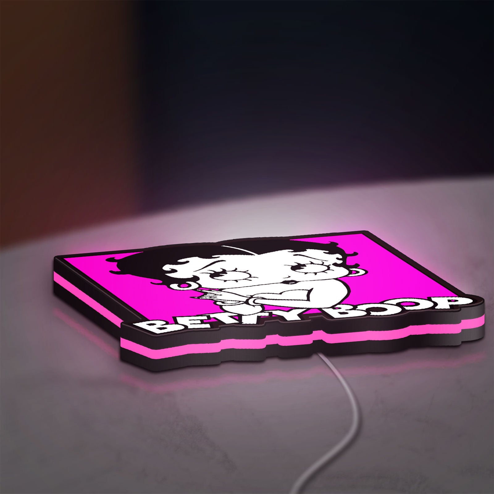 Betty Boop LED lightbox lying flat on a desk with pink glow