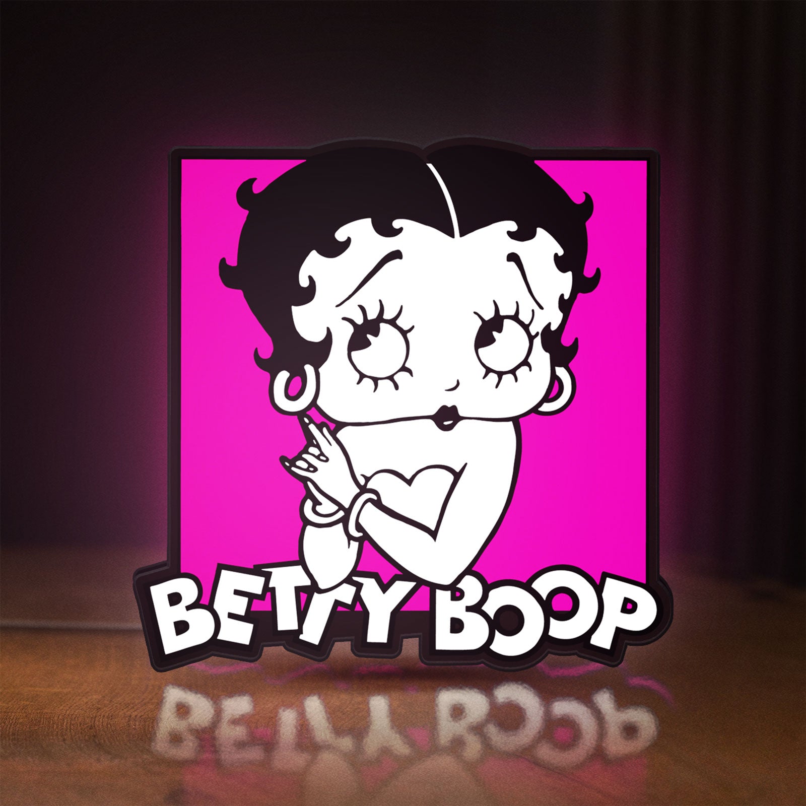 Front view of Betty Boop LED lightbox sign glowing on a wooden desk