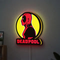 Deadpool LED lightbox hanging on a wall with yellow glow