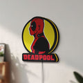 Unlit Deadpool LED lightbox mounted on a wall in daylight