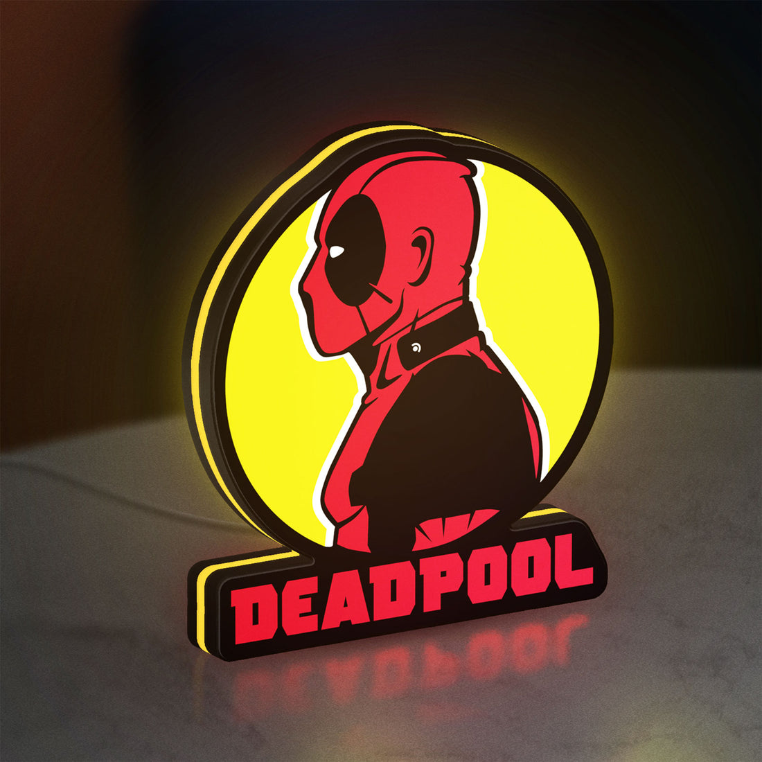 Deadpool LED lightbox hanging on a wall with yellow glow