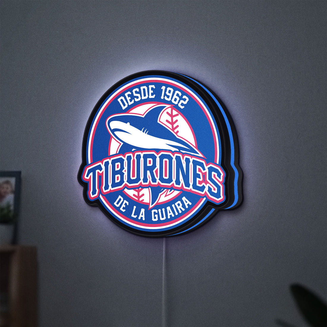 Tiburones De La Guaira LED lightbox hanging on a wall with blue glow