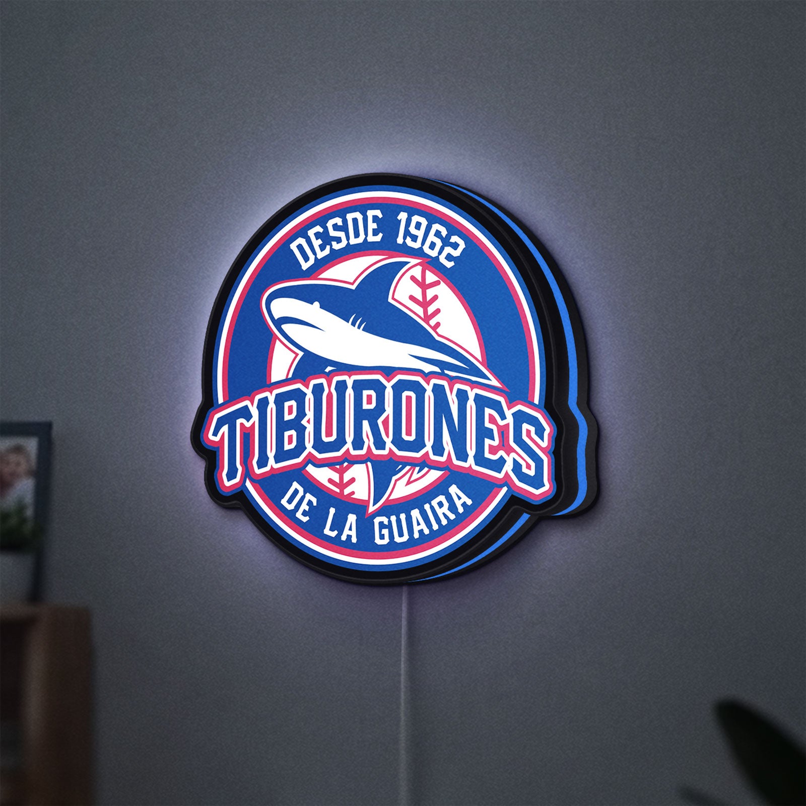 Tiburones De La Guaira LED lightbox hanging on a wall with blue glow
