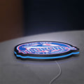 Tiburones De La Guaira LED lightbox lying flat on a desk with blue glow
