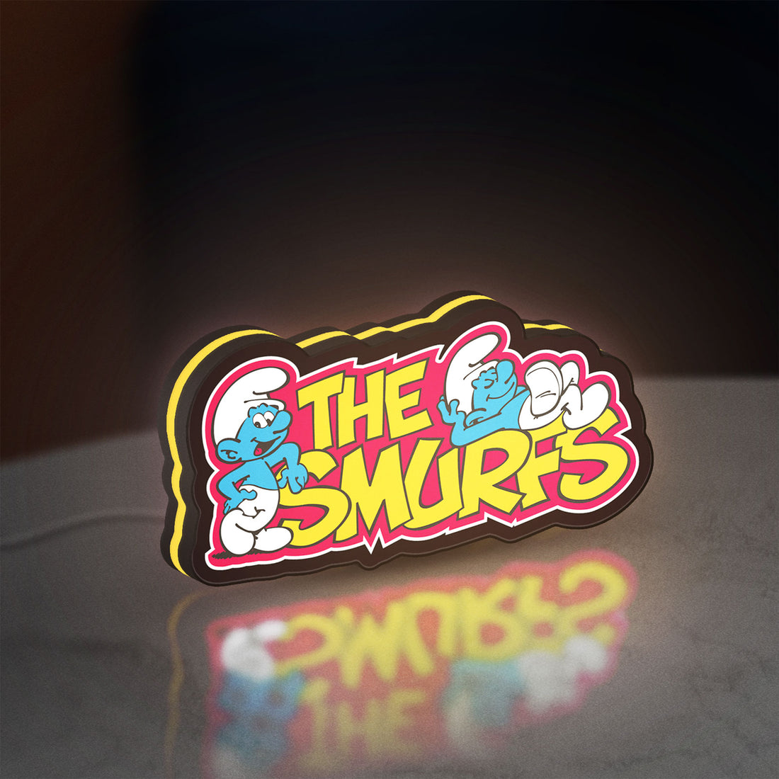 Smurfs LED lightbox hanging on a wall with yellow glow