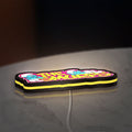 Smurfs LED lightbox lying flat on a desk with yellow glow