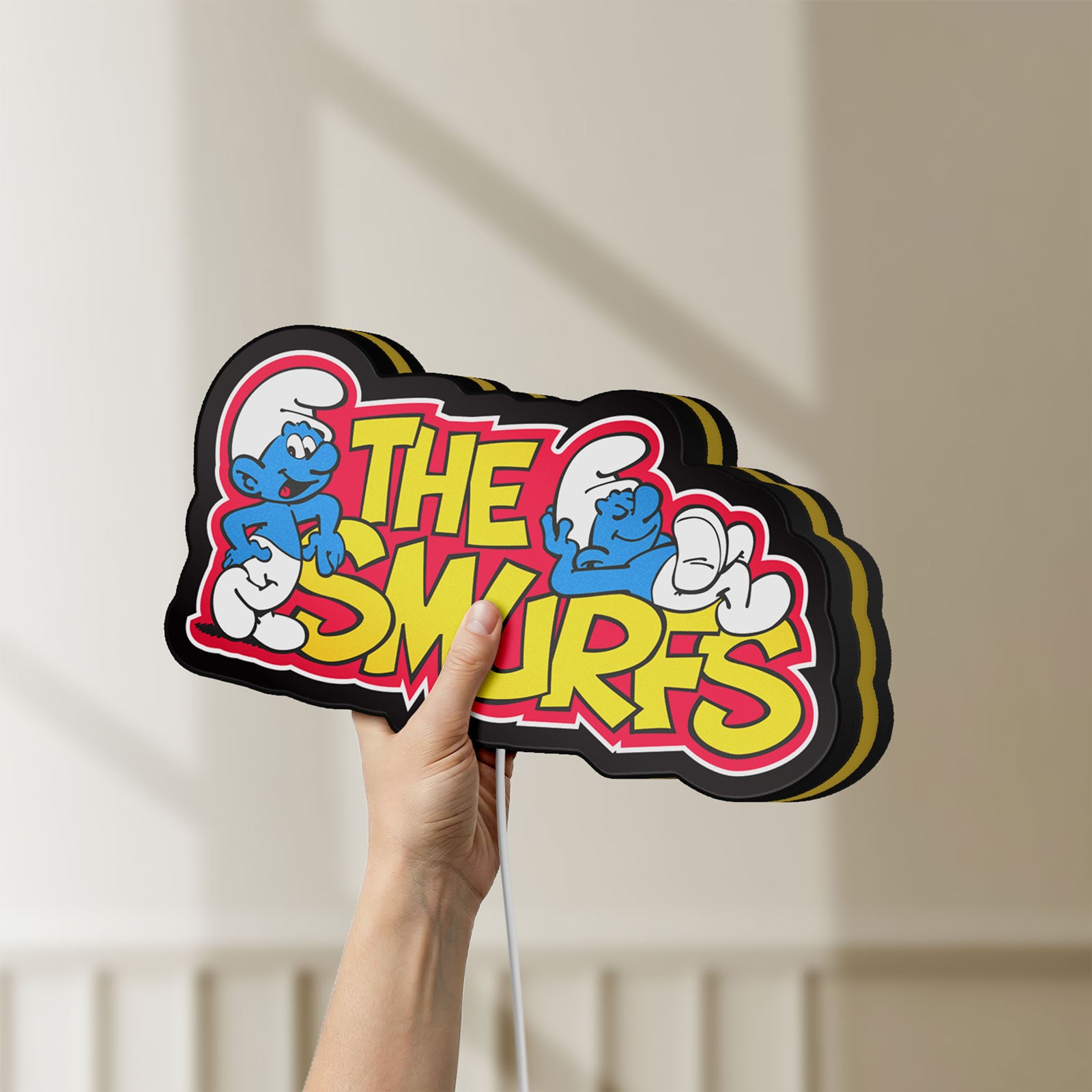 Unlit Smurfs LED lightbox held by hand to show size and details
