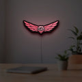 Troy Lee Designs LED lightbox hanging on a room wall with soft red light