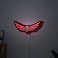 Troy Lee Designs LED lightbox hanging on a wall with red glow