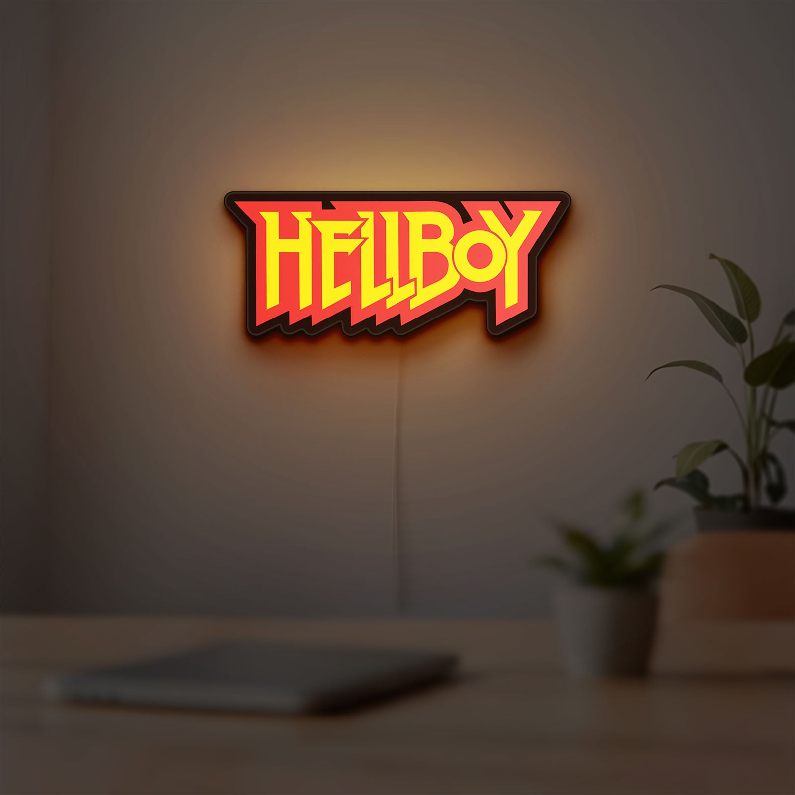 Hellboy LED lightbox hanging on a room wall with soft red light
