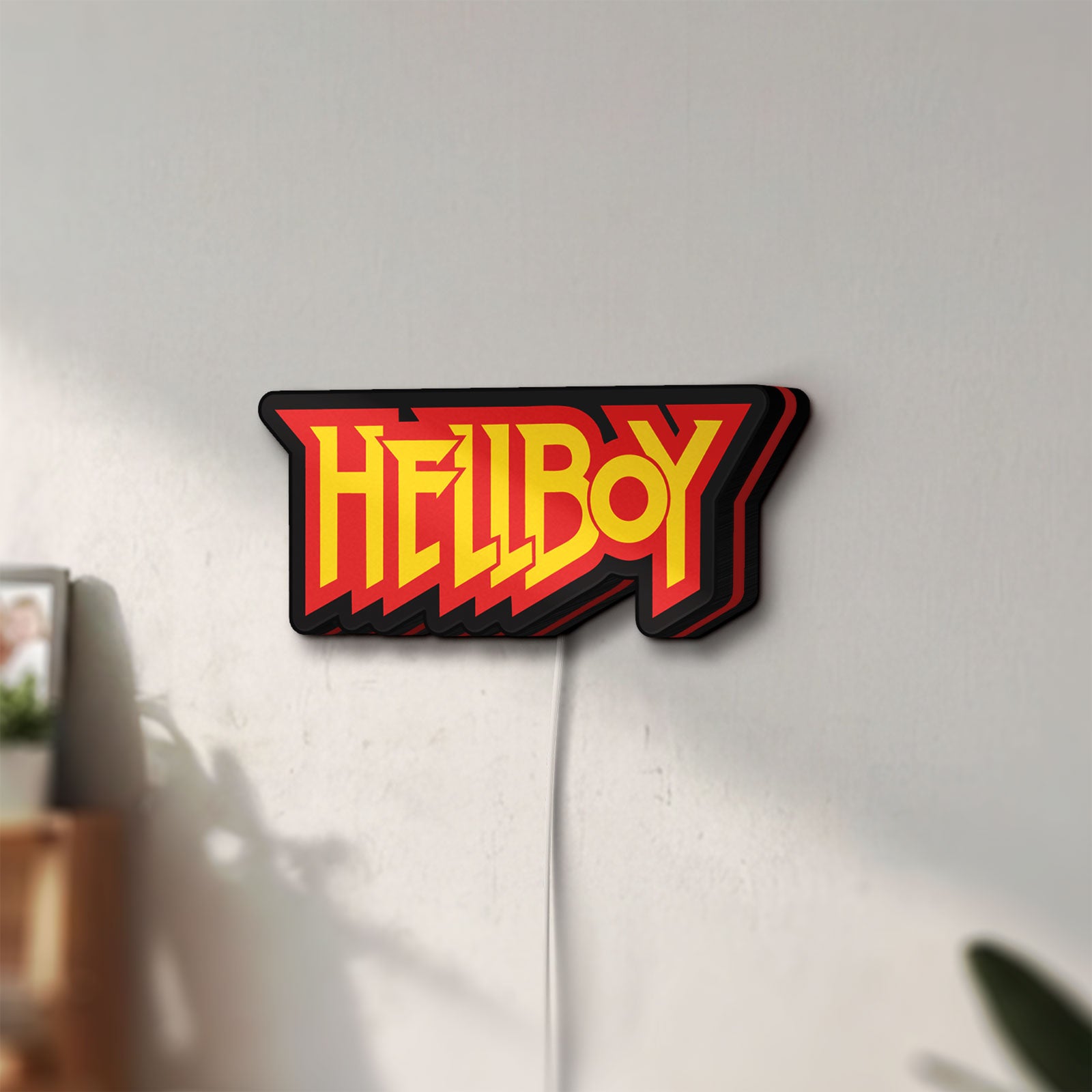 Unlit Hellboy LED lightbox mounted on a wall in daylight