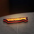 Hellboy LED lightbox lying flat on a desk with red glow