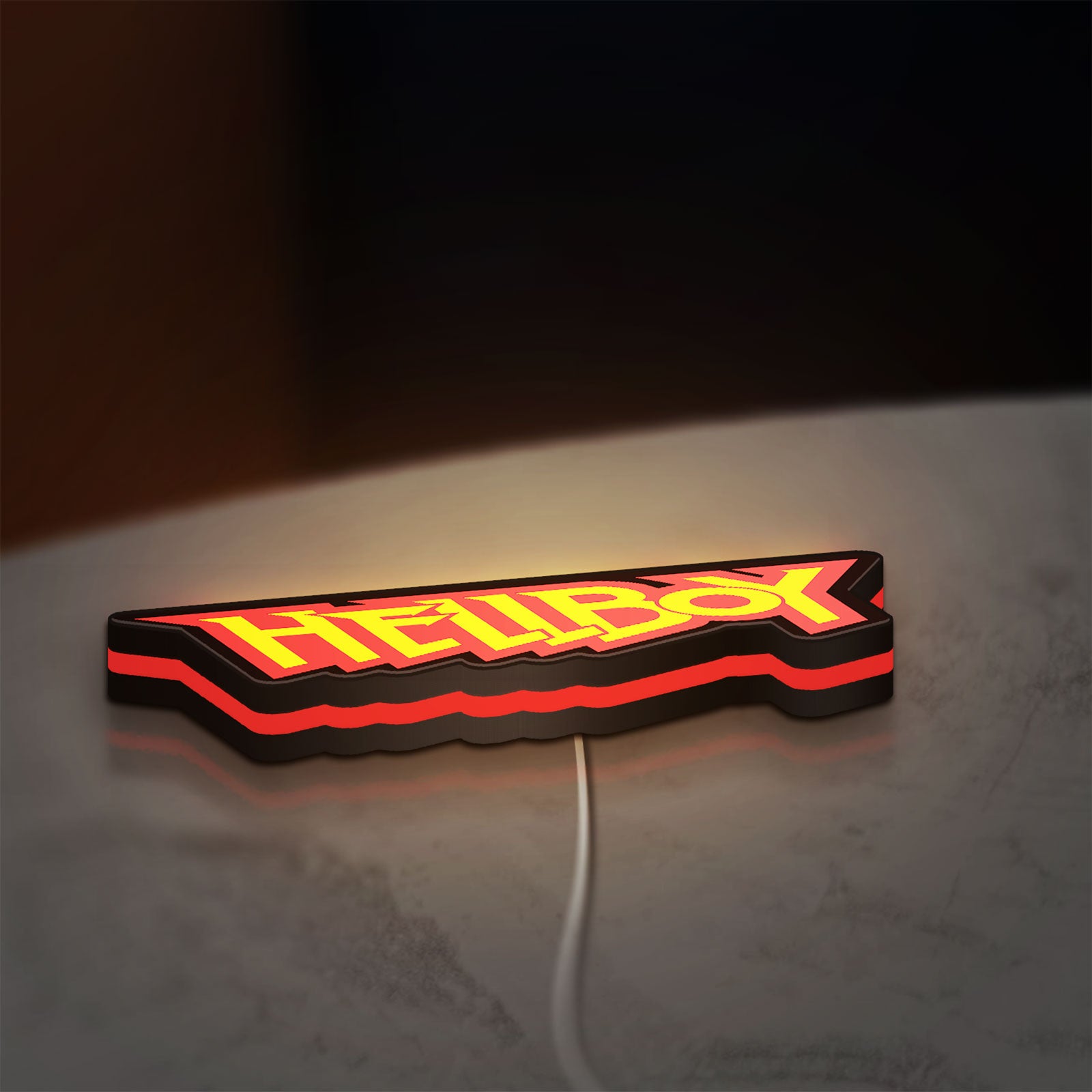 Hellboy LED lightbox lying flat on a desk with red glow