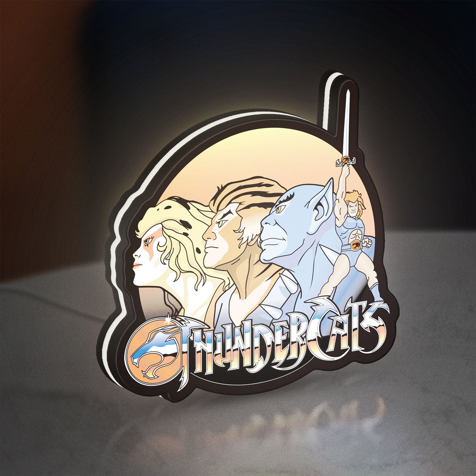 Thundercats LED lightbox standing on a desk from an angled side view with white glow
