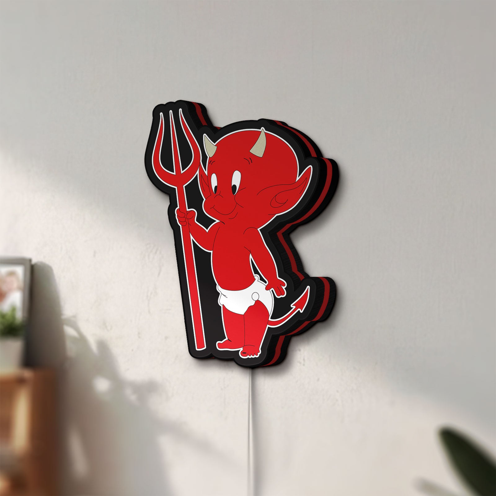 Unlit Little Devil LED lightbox mounted on a wall in daylight
