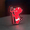 Little Devil LED lightbox standing on a desk from an angled side view with red glow