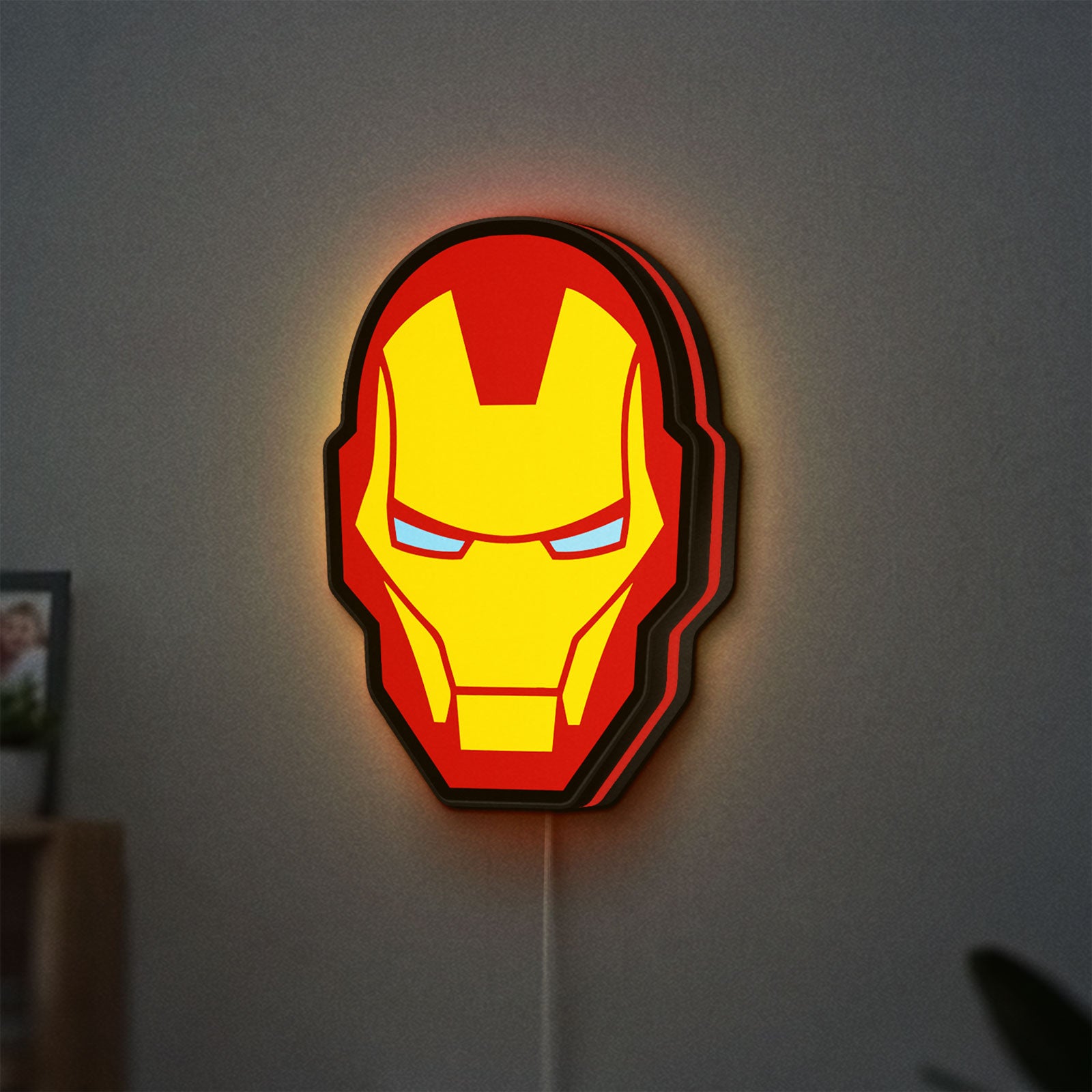 Iron Man LED lightbox hanging on a wall with red glow