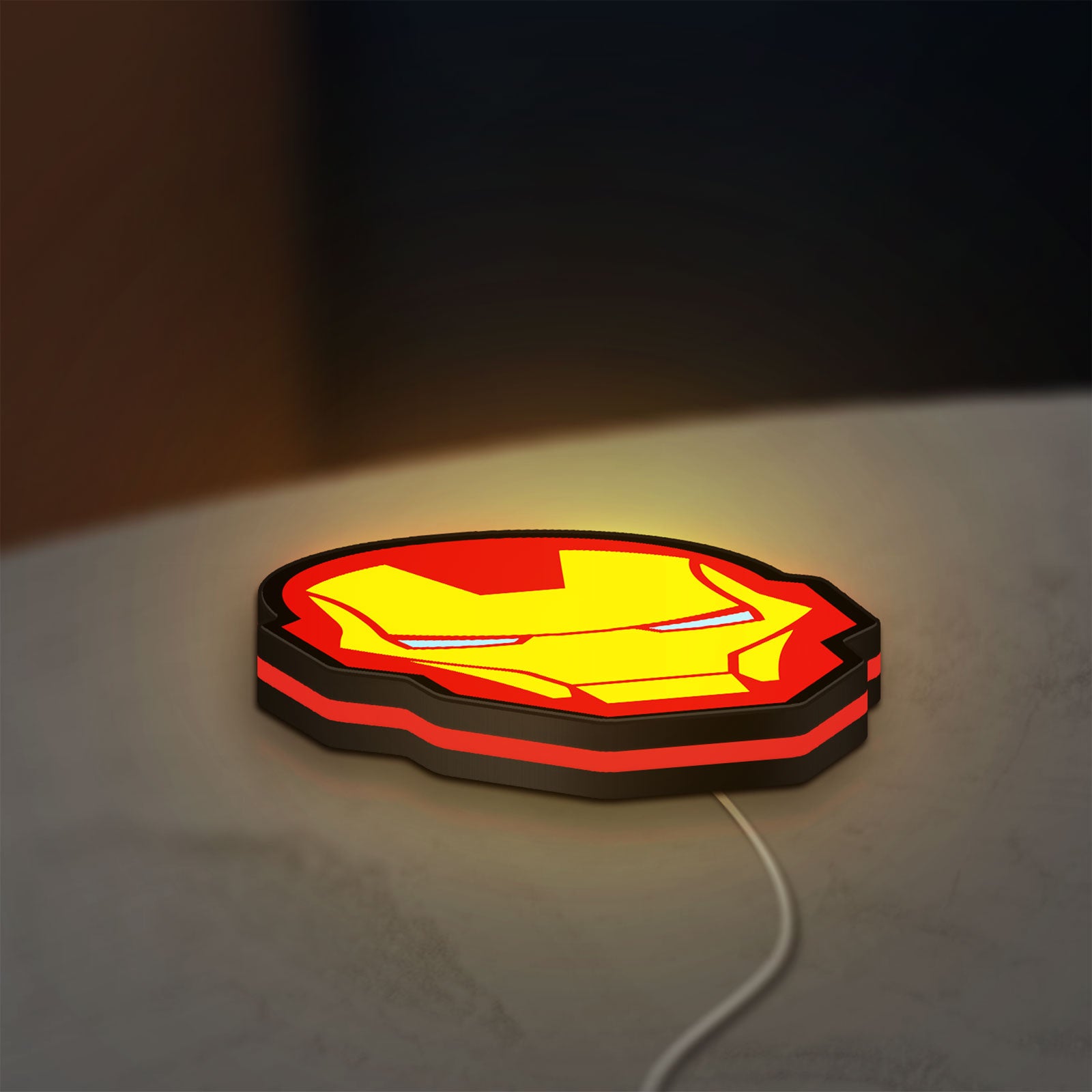 Iron Man LED lightbox lying flat on a desk with red glow