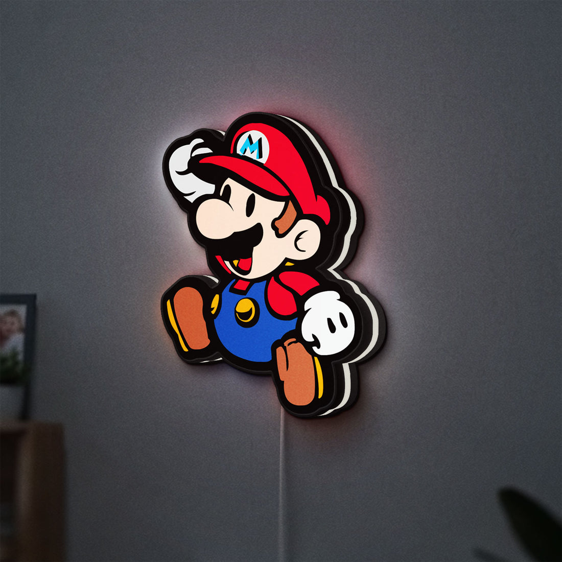 Super Mario LED lightbox hanging on a wall with white glow