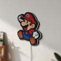 Unlit Super Mario LED lightbox mounted on a wall in daylight