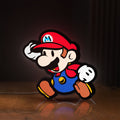 Front view of Super Mario LED lightbox sign glowing on a wooden desk