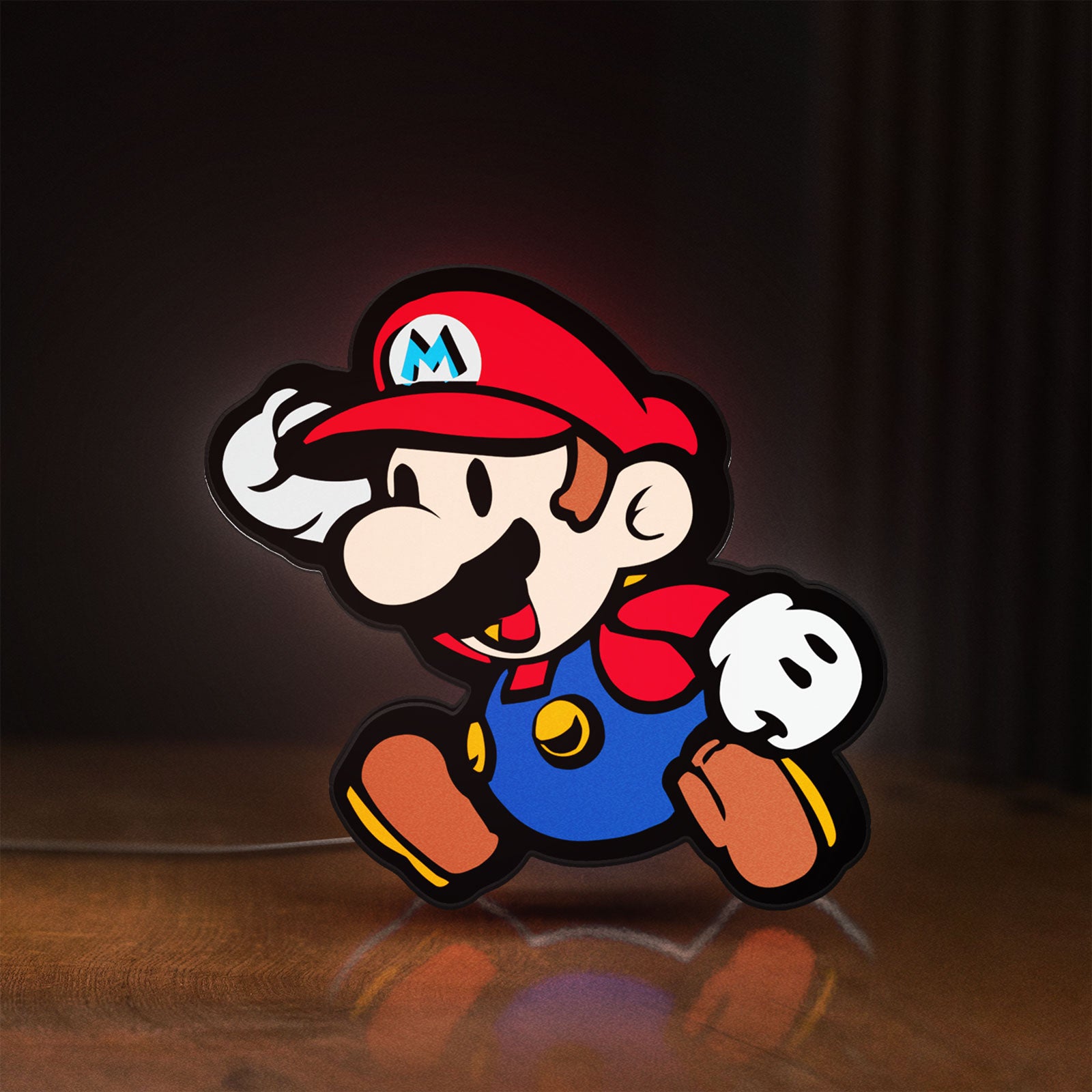 Front view of Super Mario LED lightbox sign glowing on a wooden desk
