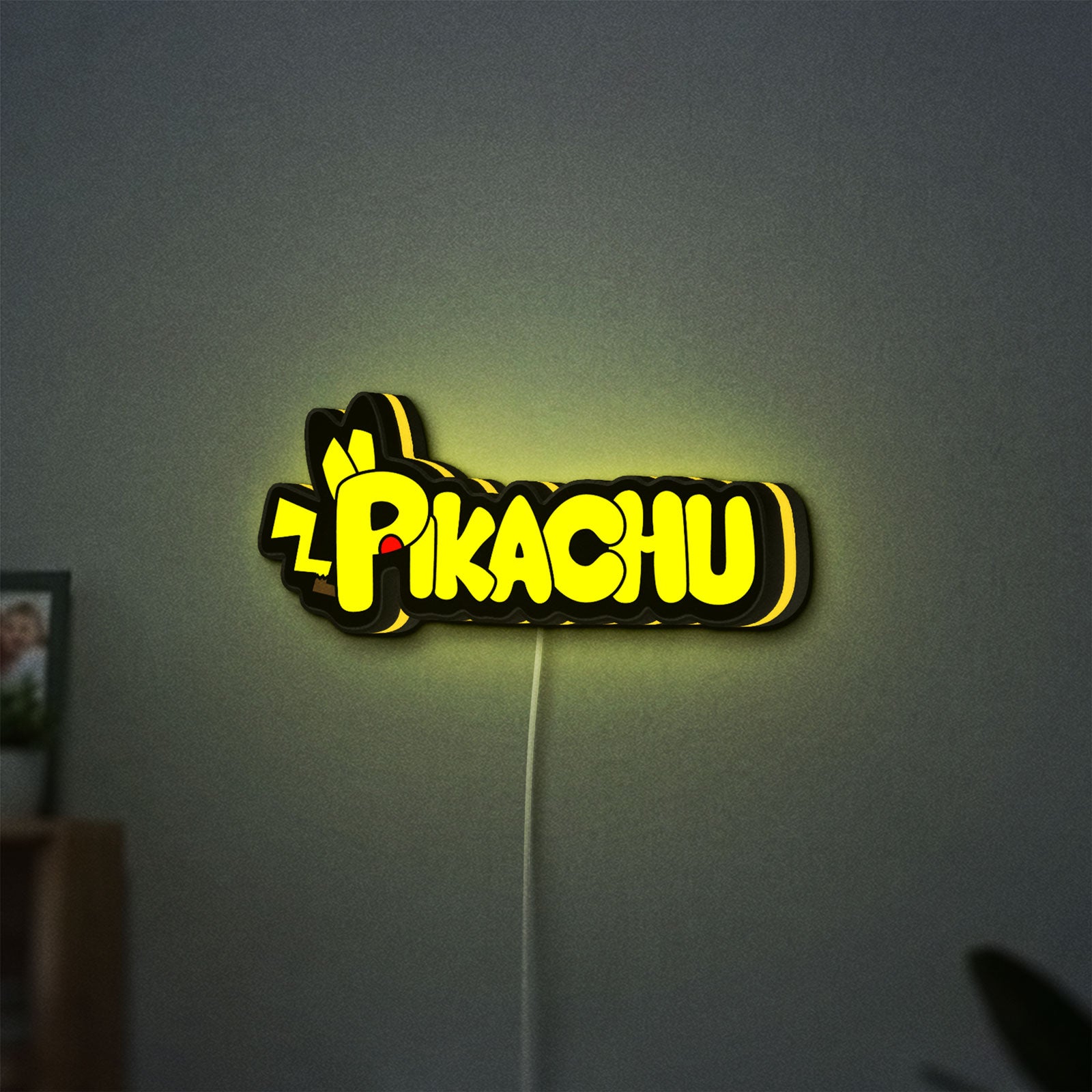 Pikachu LED lightbox hanging on a wall with yellow glow