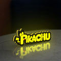Pikachu LED lightbox standing on a desk from an angled side view with yellow glow