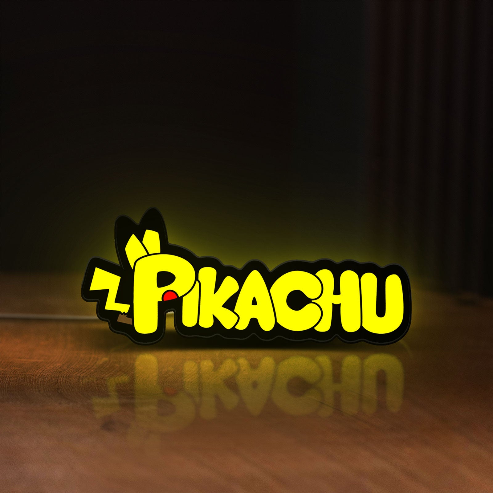 Front view of Pikachu LED lightbox sign glowing on a wooden desk