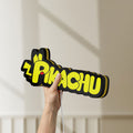 Unlit Pikachu LED lightbox held by hand to show size and details
