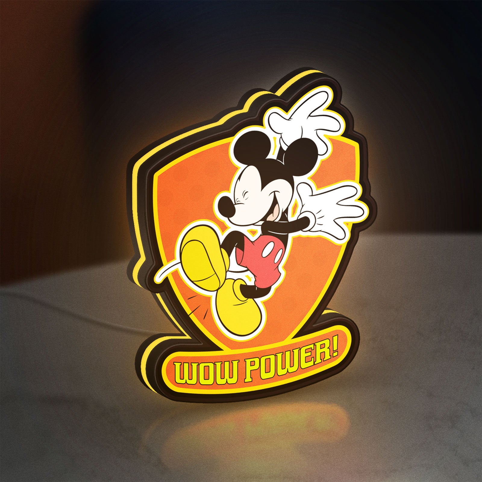 Mickey Mouse Inspired LED lightbox standing on a desk from an angled side view with yellow glow