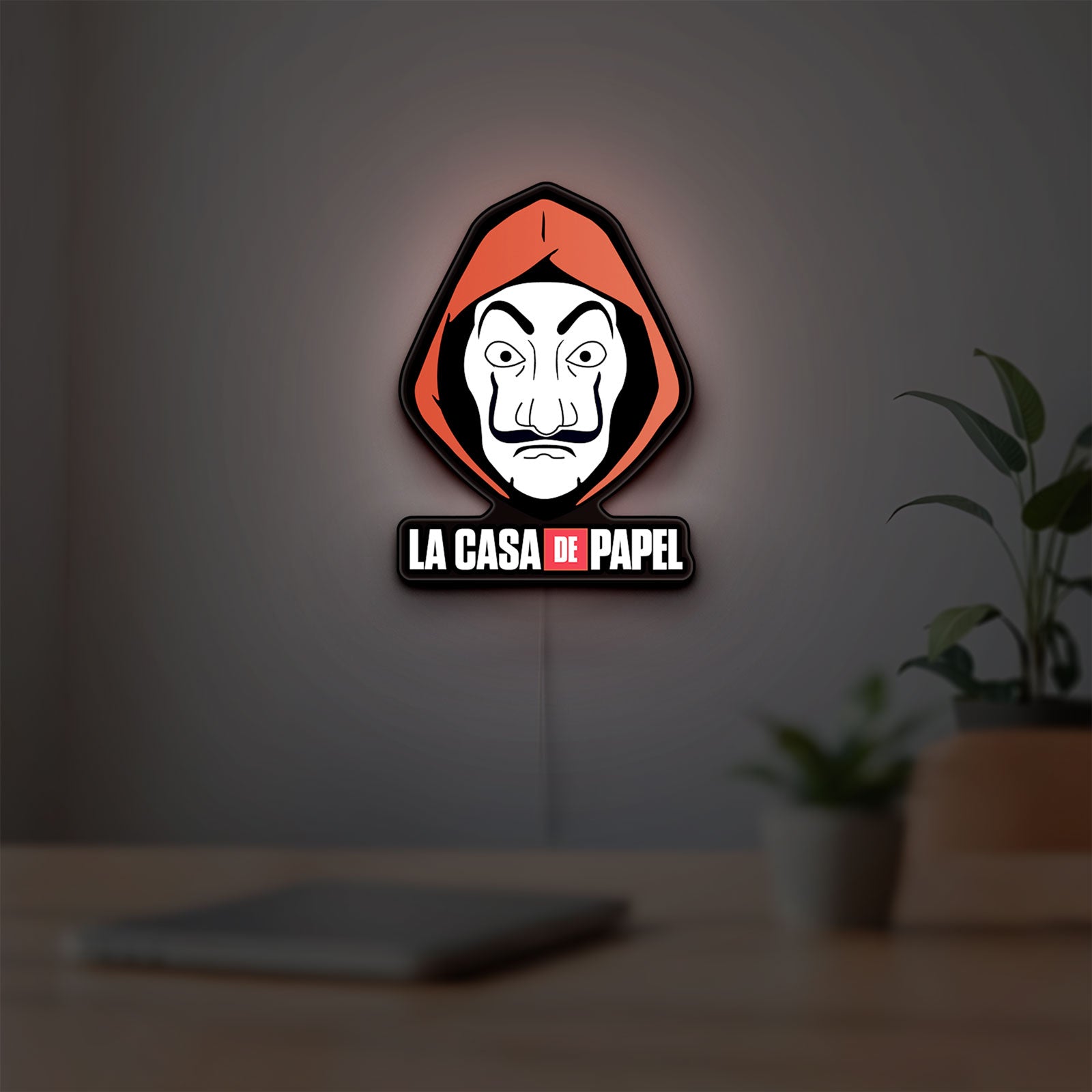 La Casa De Papel LED lightbox hanging on a room wall with soft red light