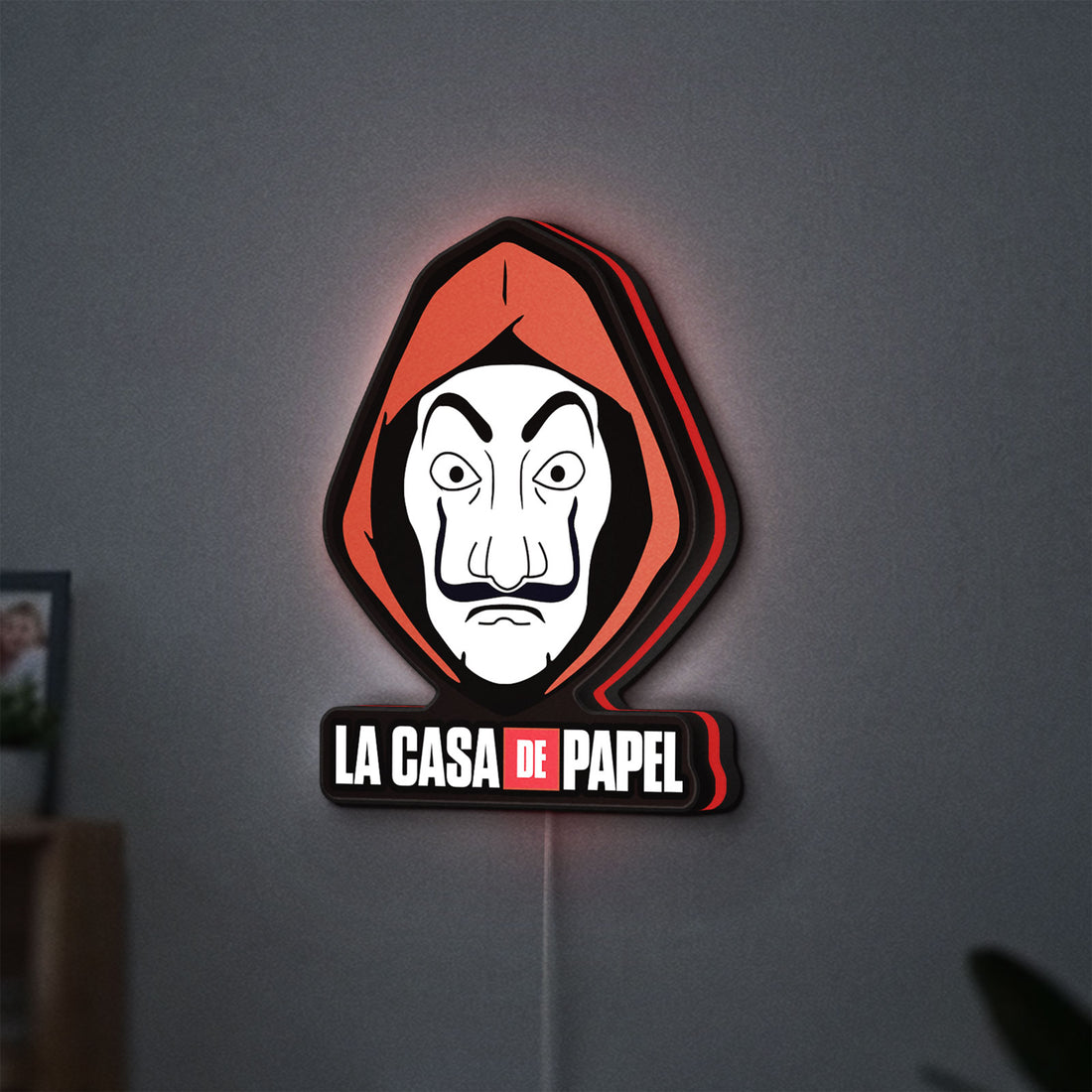 La Casa De Papel LED lightbox hanging on a wall with red glow