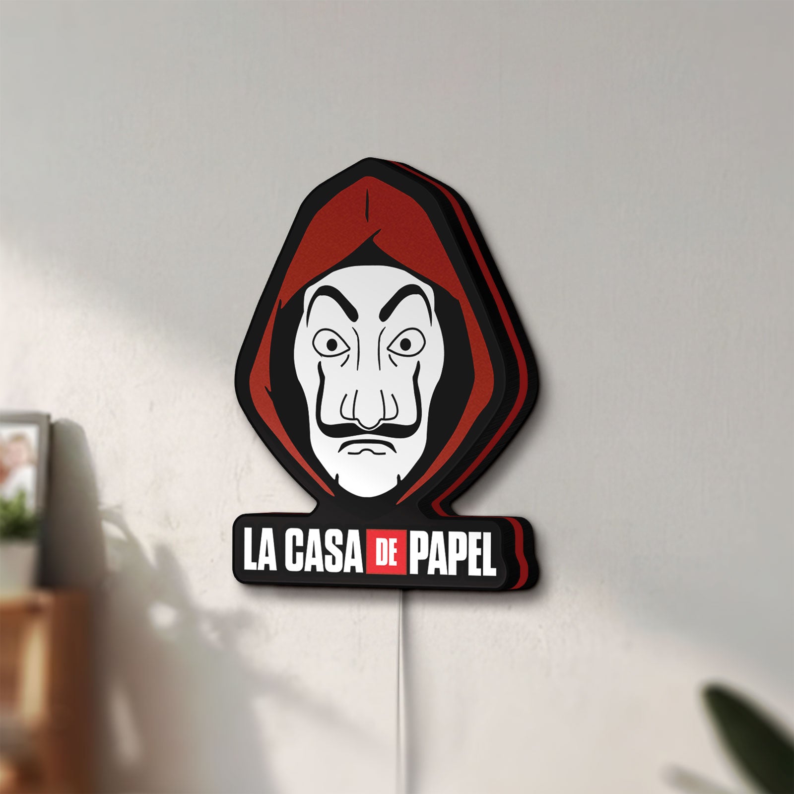 Unlit La Casa De Papel LED lightbox mounted on a wall in daylight